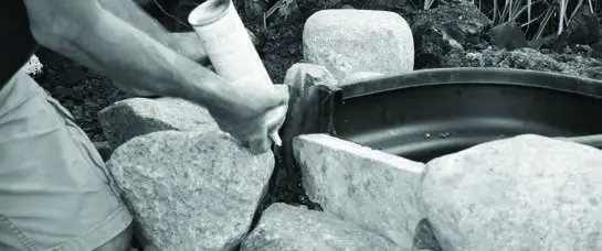 Aquascape DIY Pond Kit Instruction beneath the rocks.