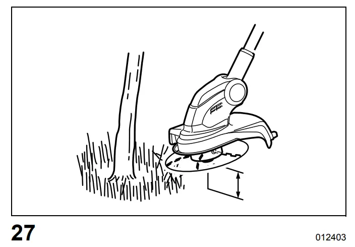 Cutting the grass near a tree