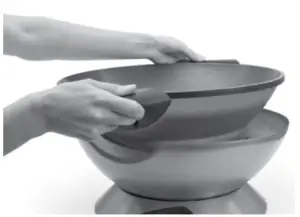 a hand holding a large bowl