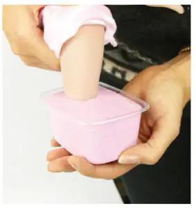 a hand holding a pink bowl