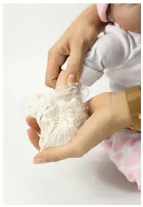 a hand holding a baby