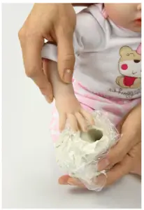 a hand holding a baby