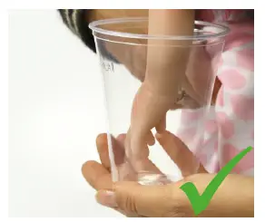 a hand holding a cup