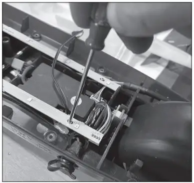 Razor W13111701106 Electric Party Pop Electric Tekno Charger Port Replacement Instruction Manual - Using a Phillips screwdriver remove the screw that holds the LED lights in place and move the light strip to the side