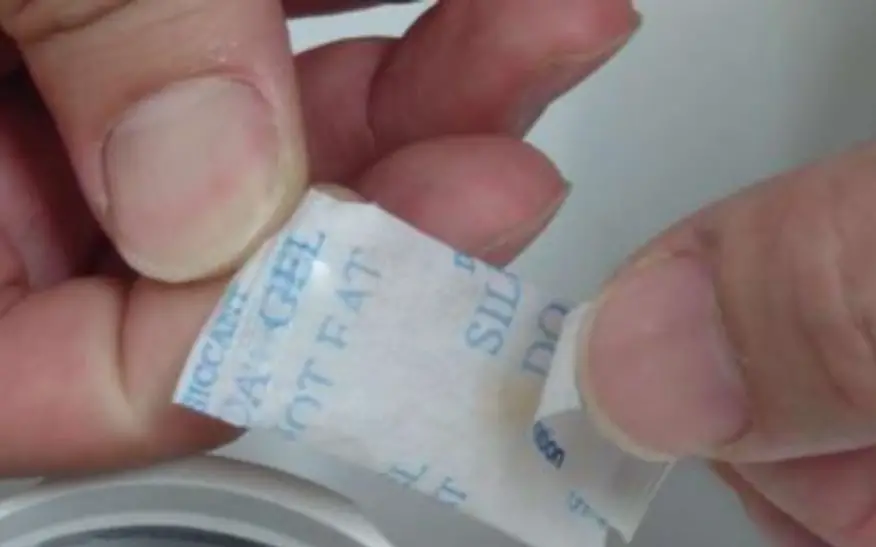 Stick a double-sided tape on desiccant bag