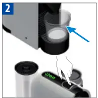 Place a cup under the coffee outlet