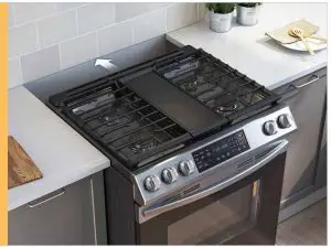 a stove top oven sitting inside of a kitchen