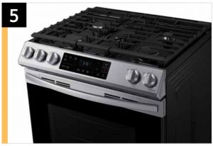 a stove top oven sitting inside of a kitchen