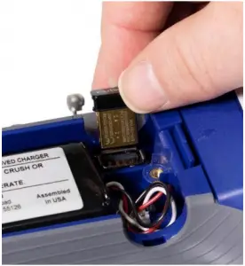 a hand holding a blue object