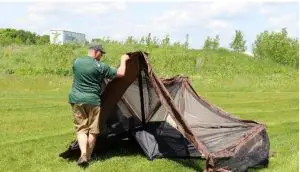 a man with a tent in a field