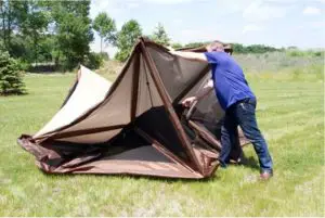 a man with a tent in a field