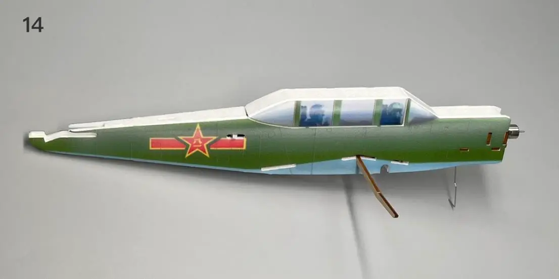 a green airplane next to a plane